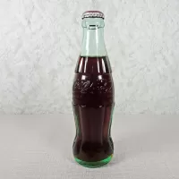 Ottumwa Iowa vintage 8 oz full hobbleskirt no refill Coke bottle with Coca Cola Classic cap: Front - Click to enlarge