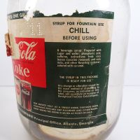 Vintage Coca Cola Coke fountain syrup thumb handle gallon glass jug with paper label and metal screw top: Left Label - Click to enlarge